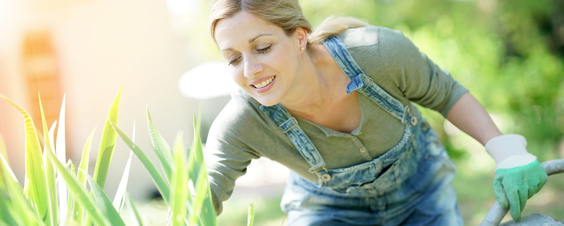 Smiling blond woman gardening