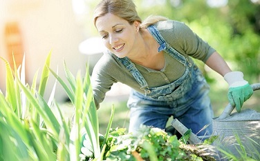 Smiling blond woman gardening