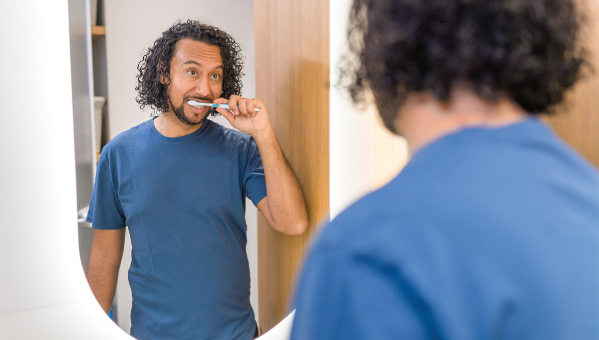 man-brushing-teeth-in-mirror-1200x683.jpg