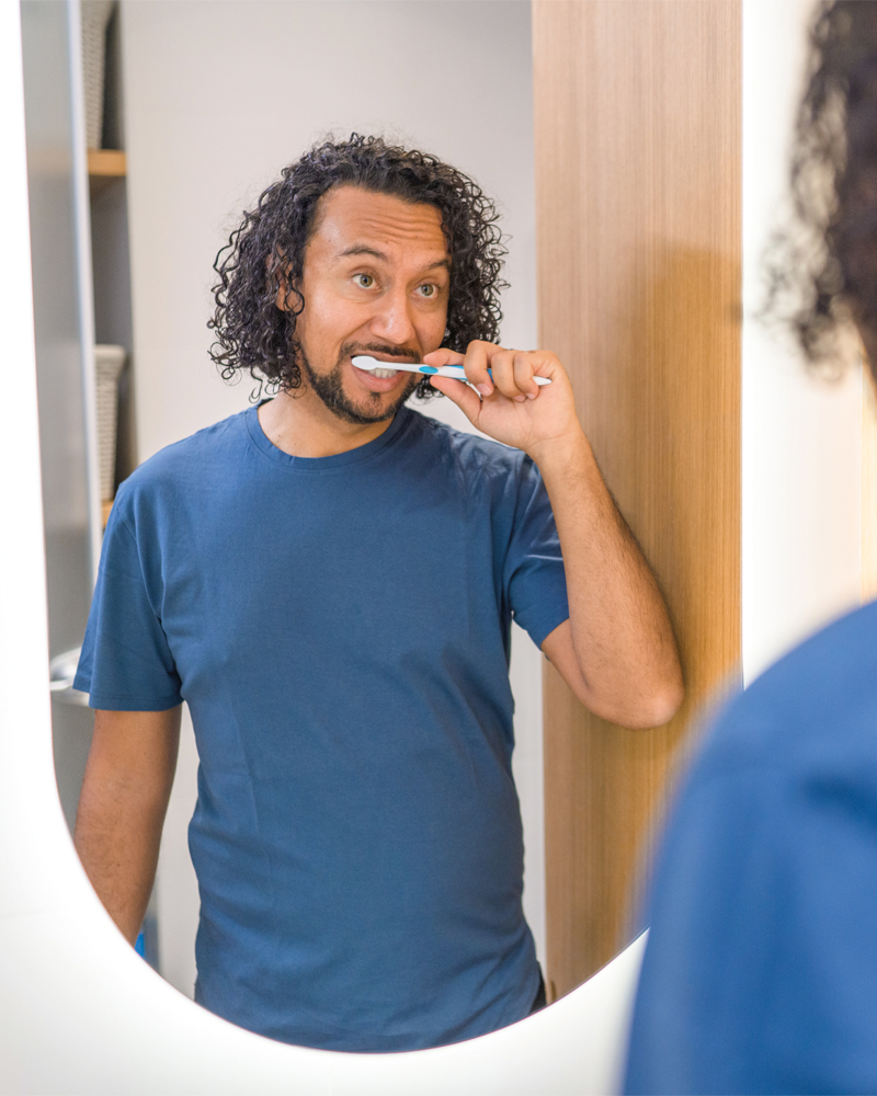 man-brushing-teeth-in-mirror-800x1000.jpg