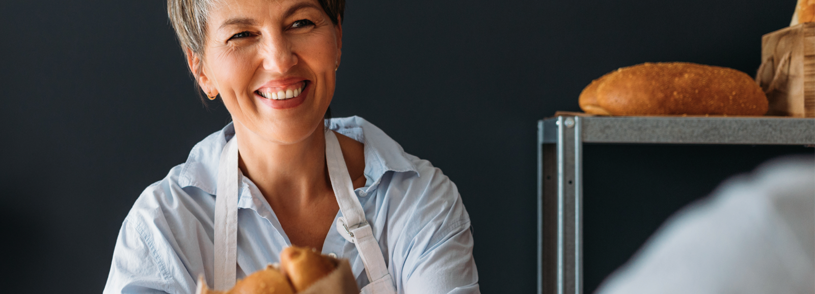 woman-selling-bread-1600x578.png