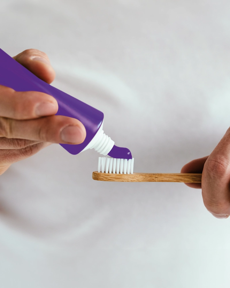 purple-toothpaste-on-a-toothbrush-800x1000.webp