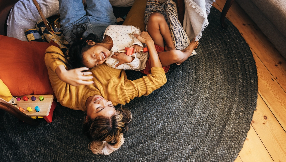 mom-and-daughter-laughing-on-the-floor-1200x683.webp