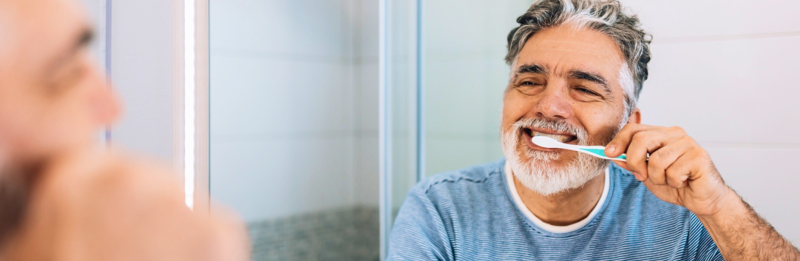 ESP-older-man-brushing-teeth-in-mirror-1600x522.jpeg