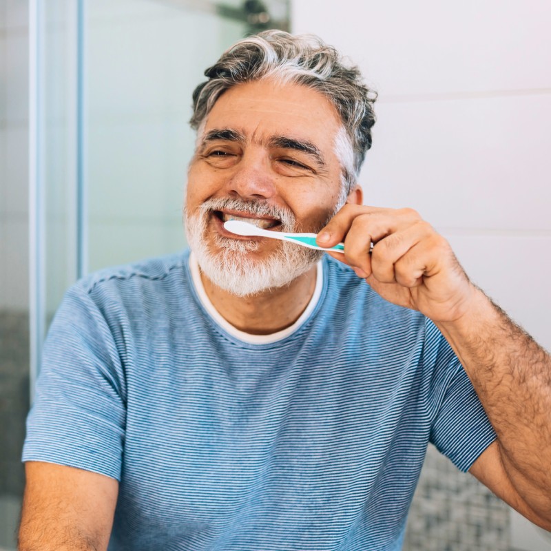 ESP-older-man-brushing-teeth-in-mirror-800x800.jpeg